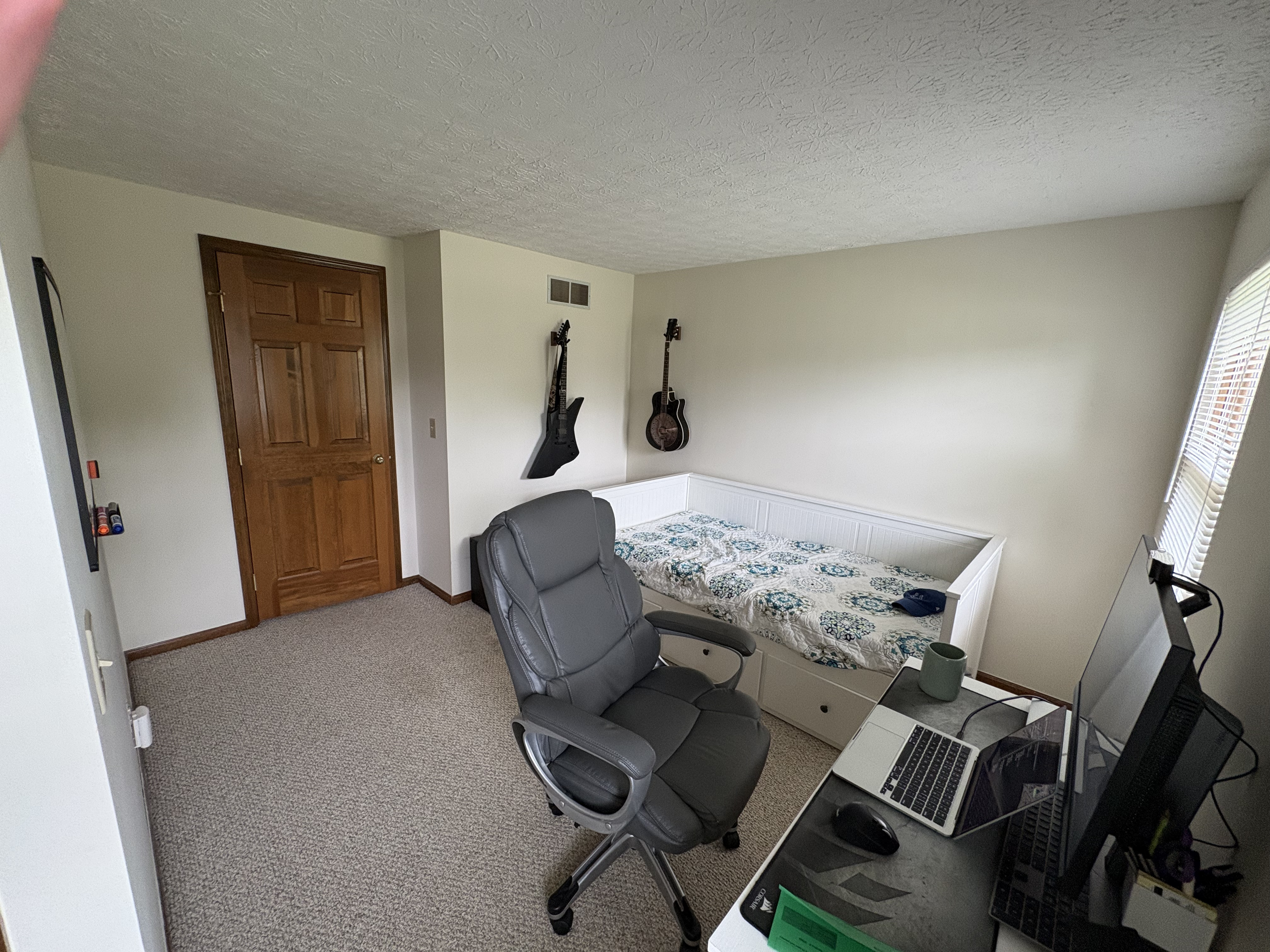 Viewing the bedroom walls facing the entry before interior painting.